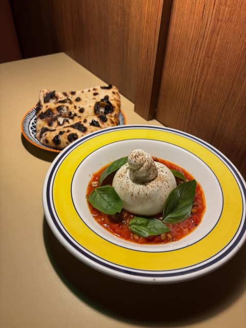 Burrata on warm roasted peppers with pine nuts and basil
